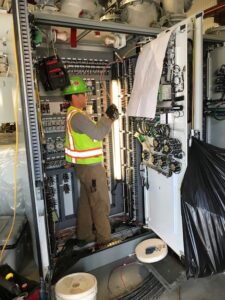 Electrician wearing safety vest and gear
