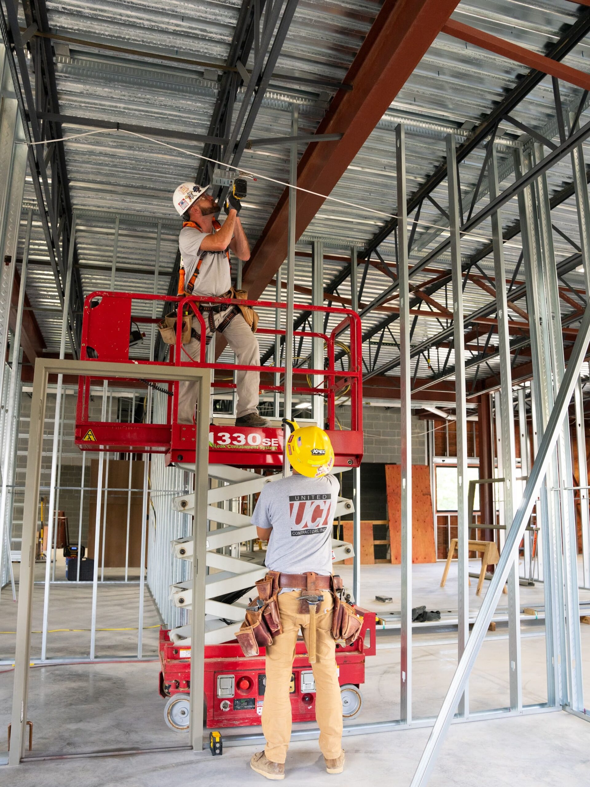 UCI Contractors on electric lift wearing hard hats