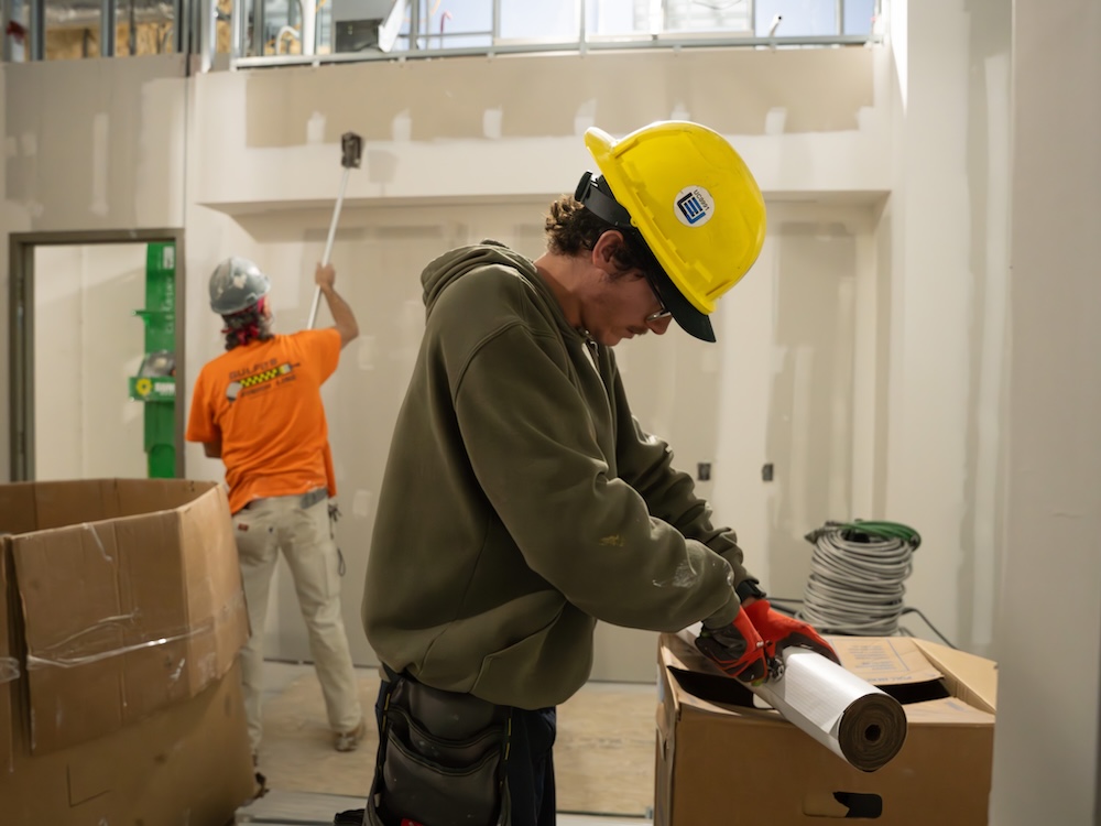MVCC Student wearing hoodie and hard hat at construction site