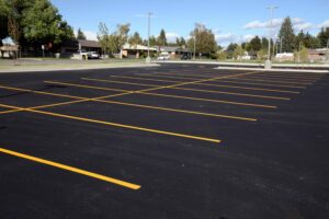 freshly paved parking lot - dark asphalt and freshly painted yellow lines